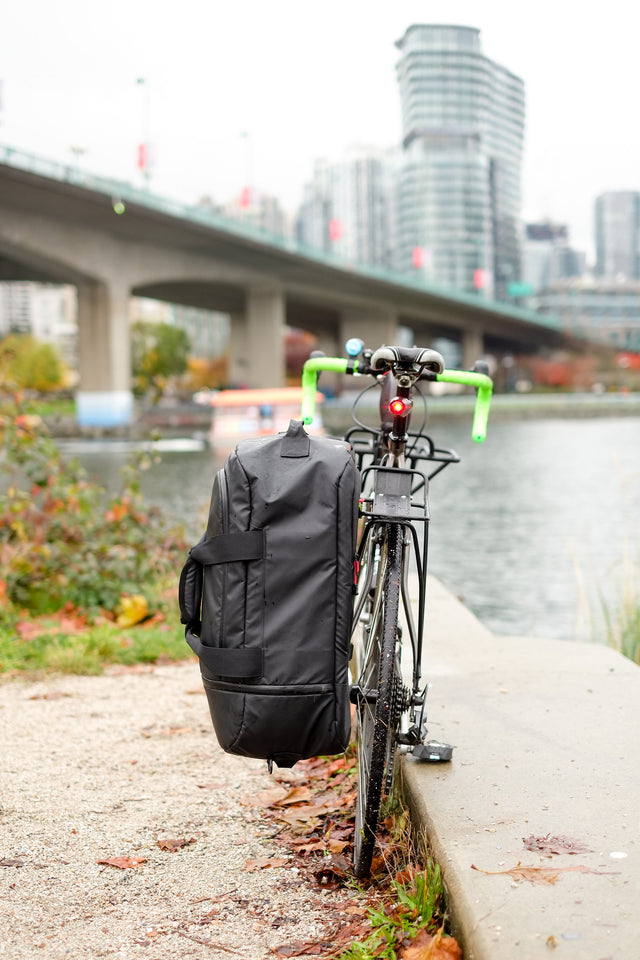 biking in the rain with the Two Wheel Gear Duffle bag on the rack of bike.