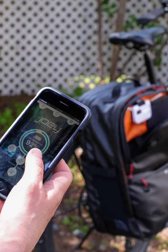 Two Wheel Gear Joey Smart phone app connects to unit in Alpha Pannier Backpack.